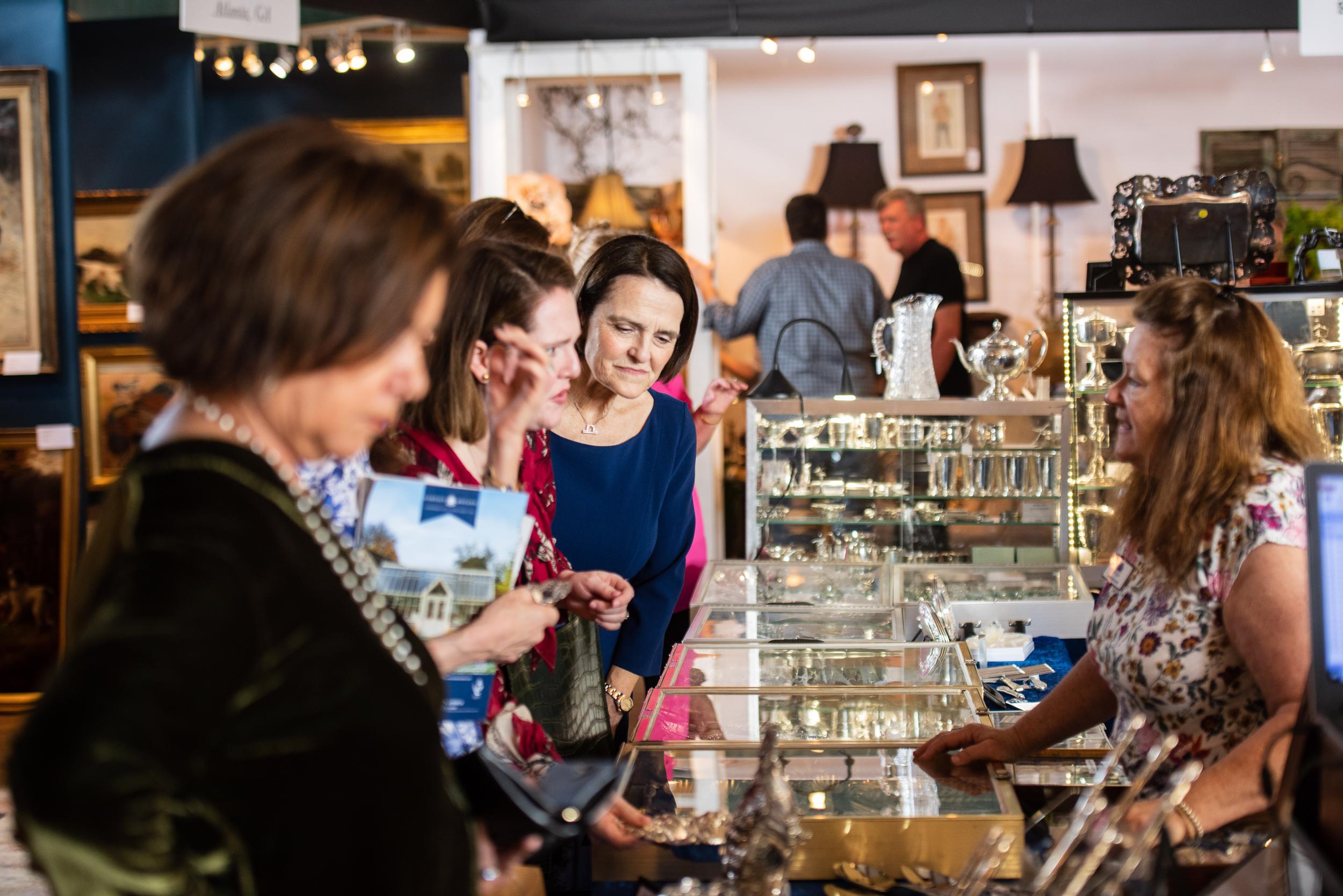 Photo of women looking at antiques