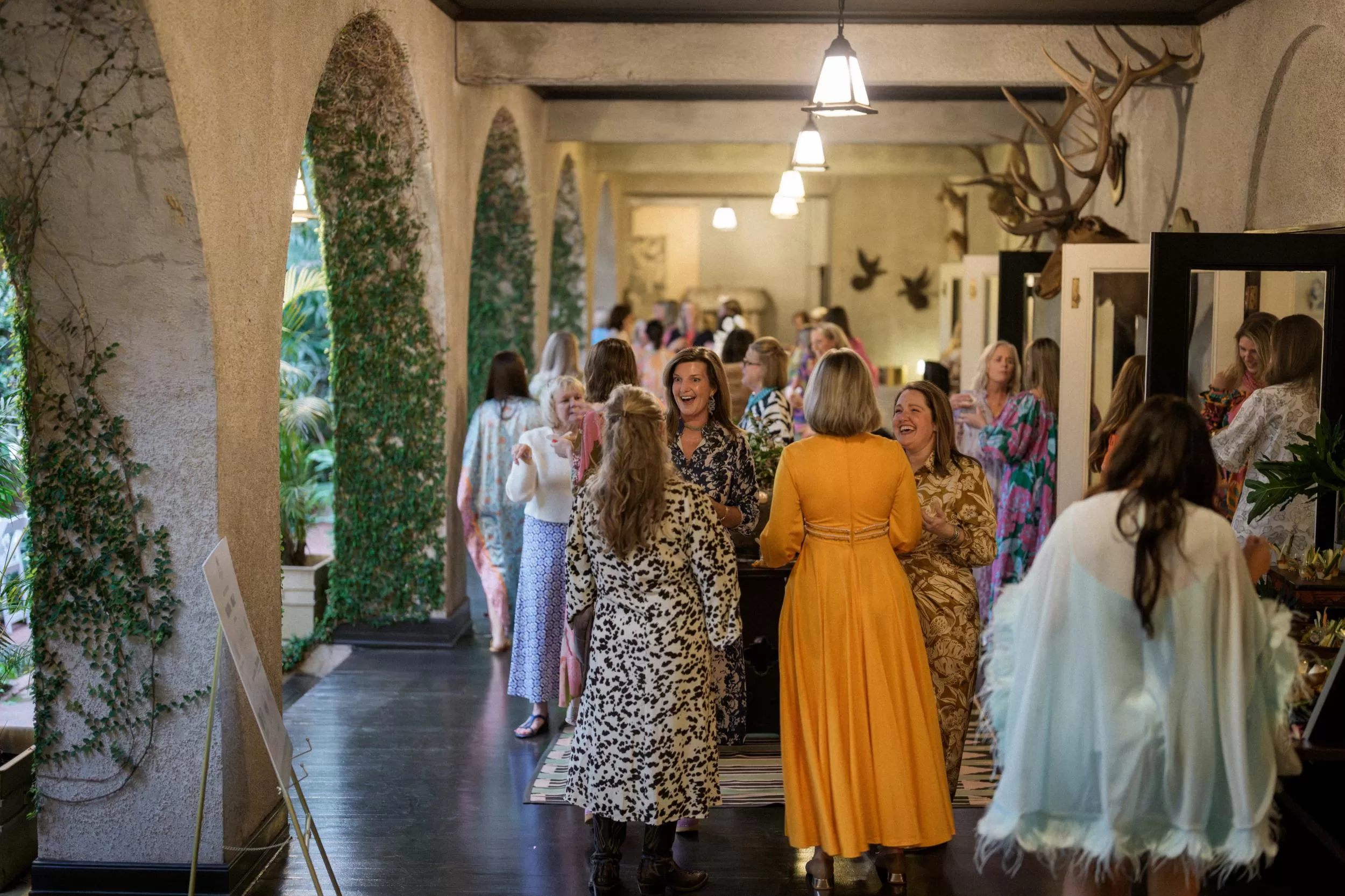women speak in an outdoor hallway